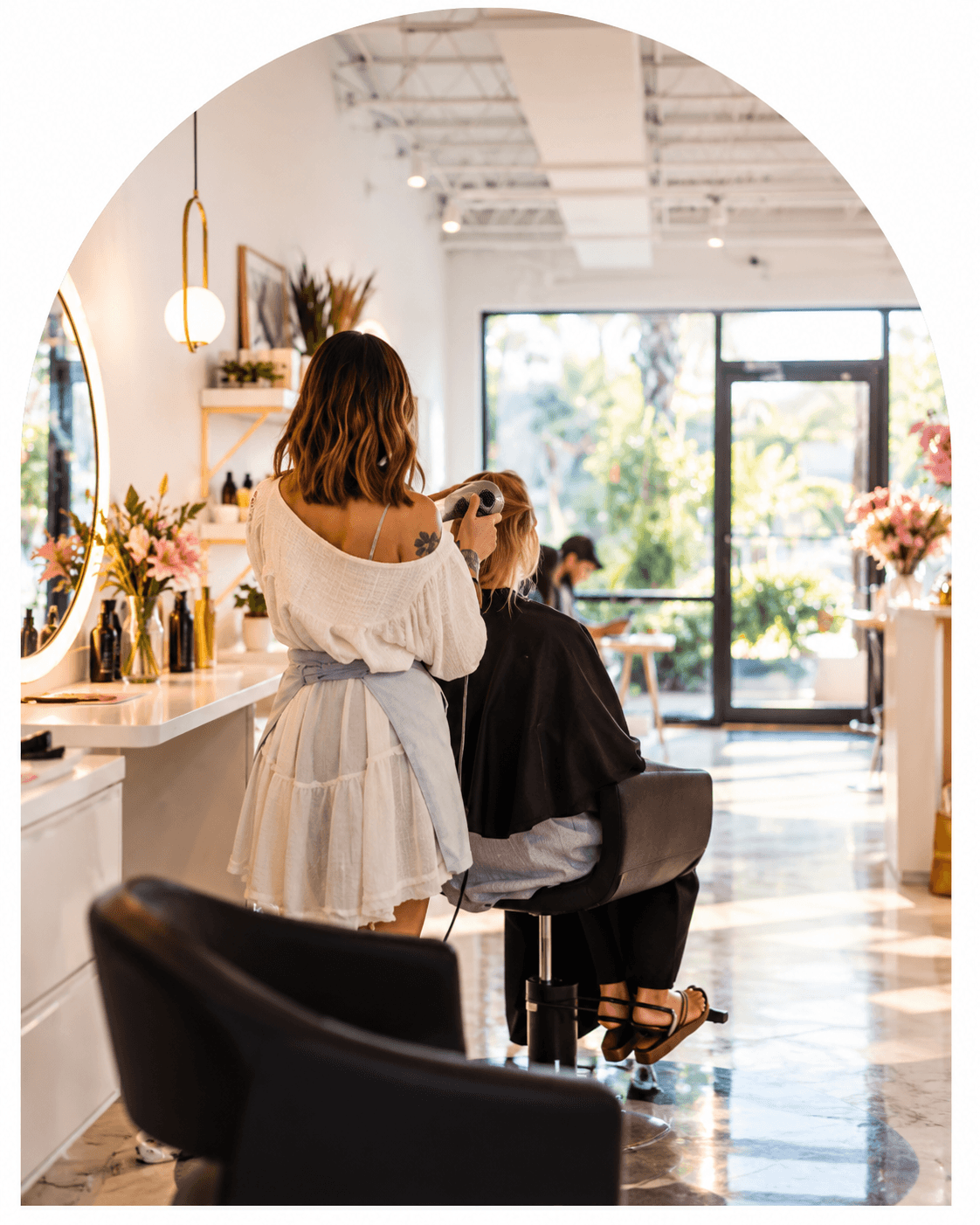 A beauty professional caring for a client in a salon